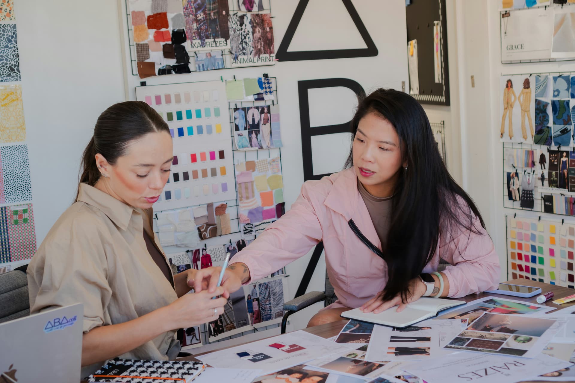 A business owner and a creative team member reviewing brand colours and references together